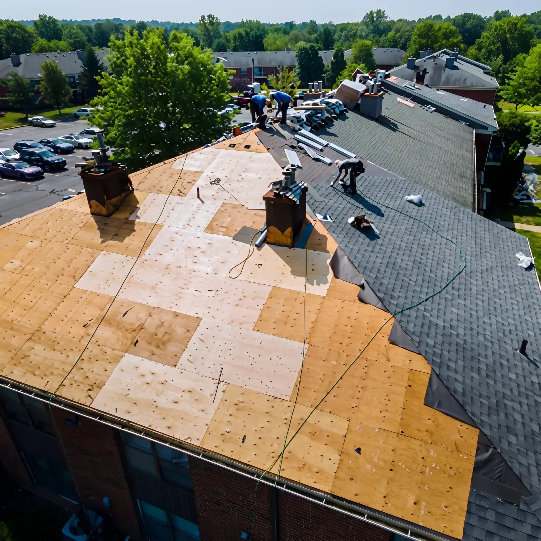 Roofing team installing protective shingles