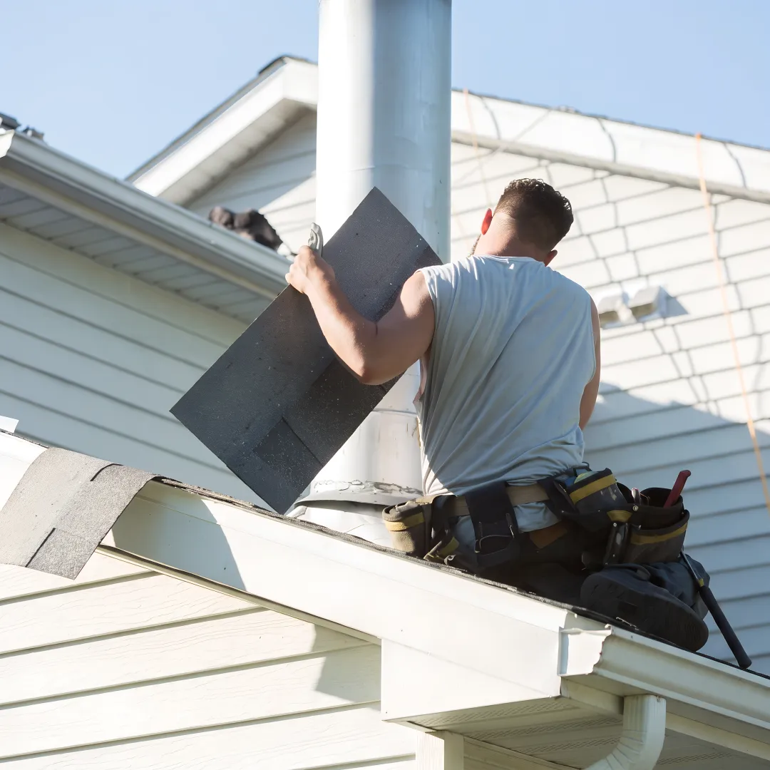 Roofer inspecting a residential roof