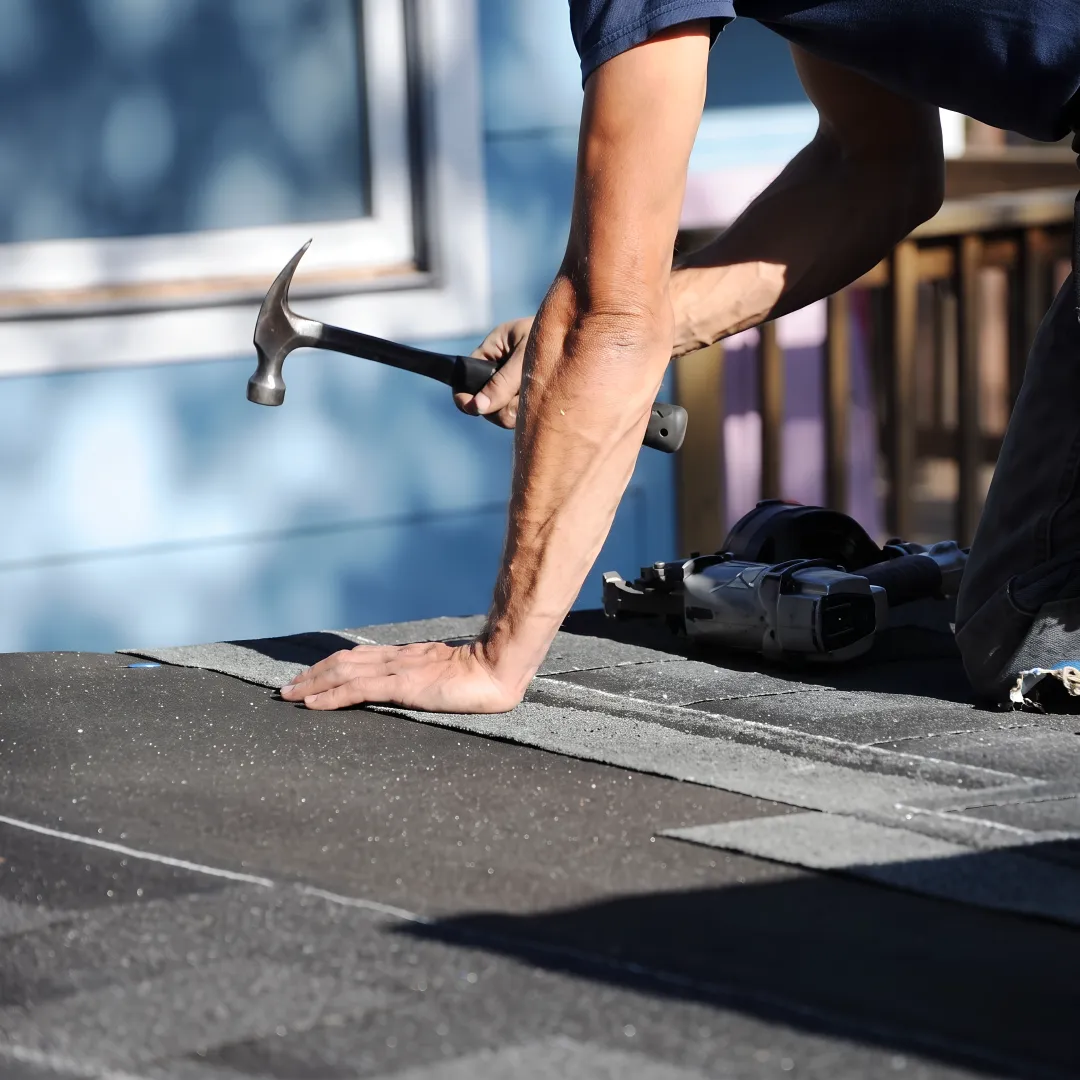 Roofing professional inspecting a completed roof