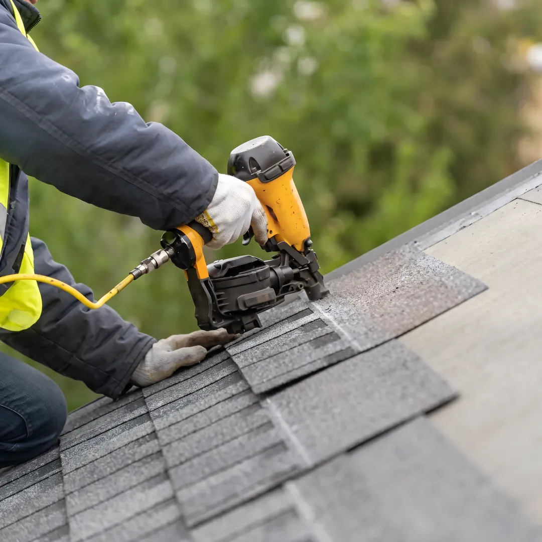 Roofing crew installing protective shingles