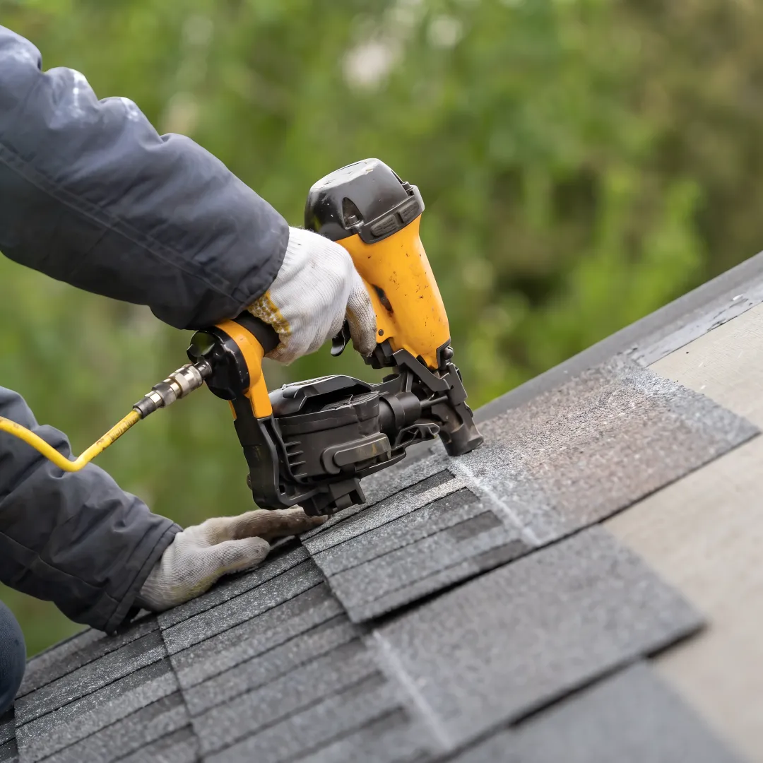 Roofing crew installing shingles on a home