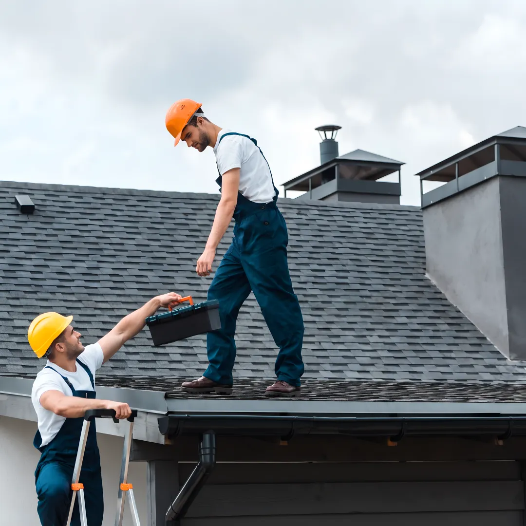 Roofing team assessing storm damage