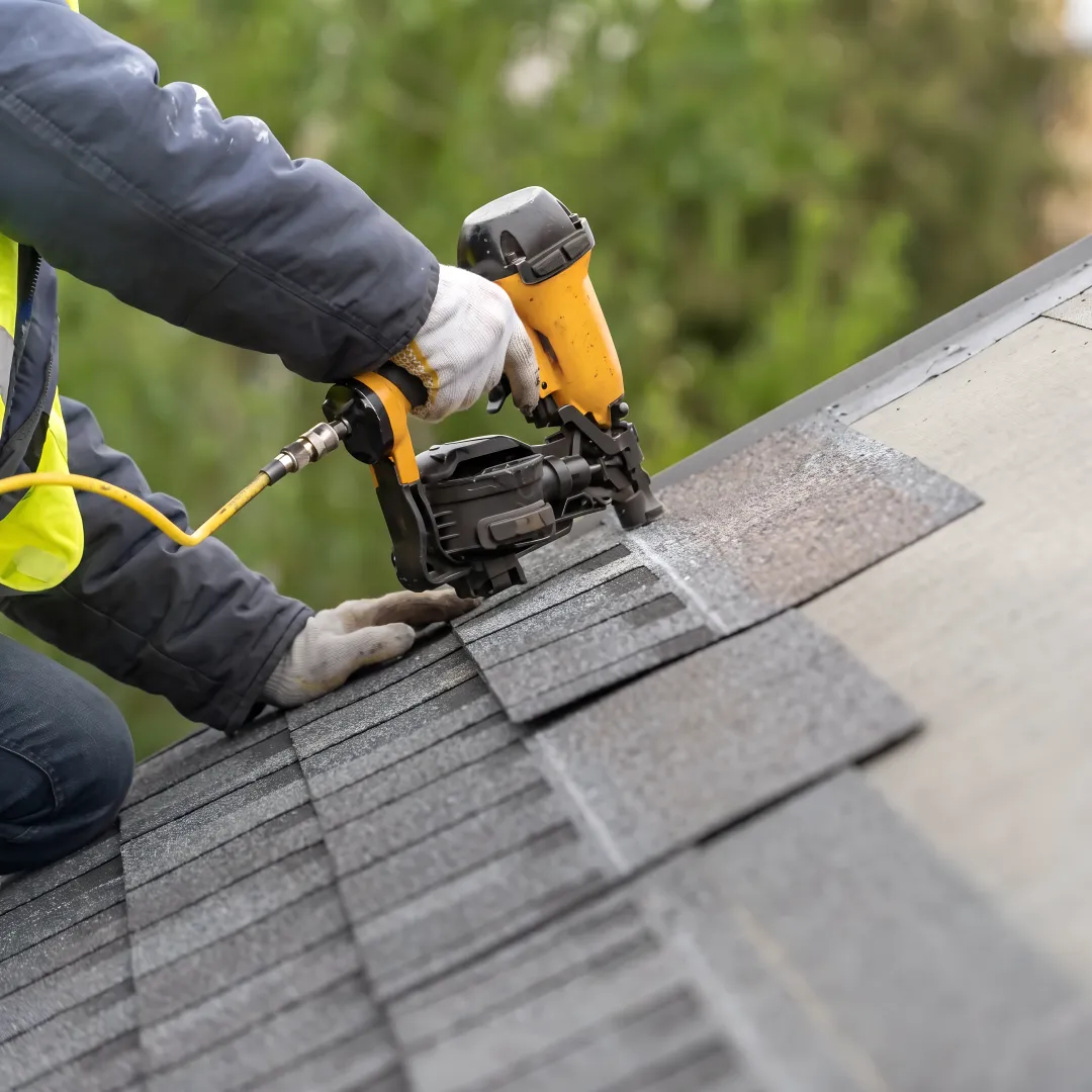 Roofing professional inspecting new shingle installation