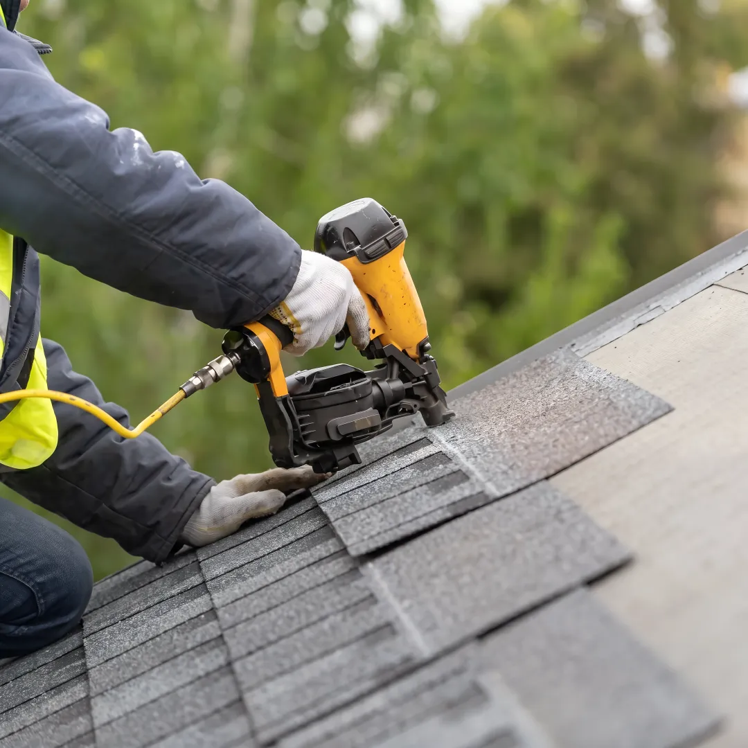 Roofing professional repairing shingles and flashing