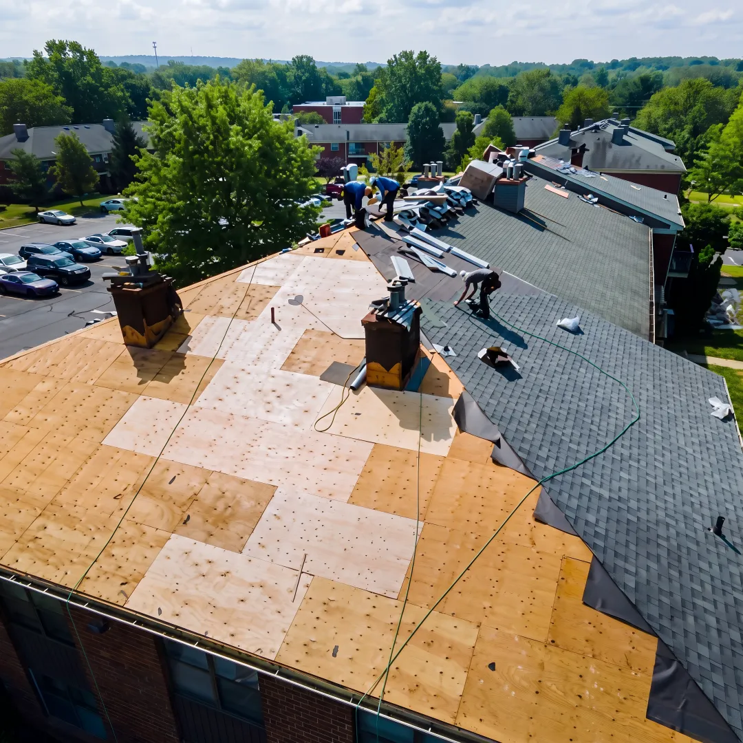 Roofer inspecting shingles on a South Florida home