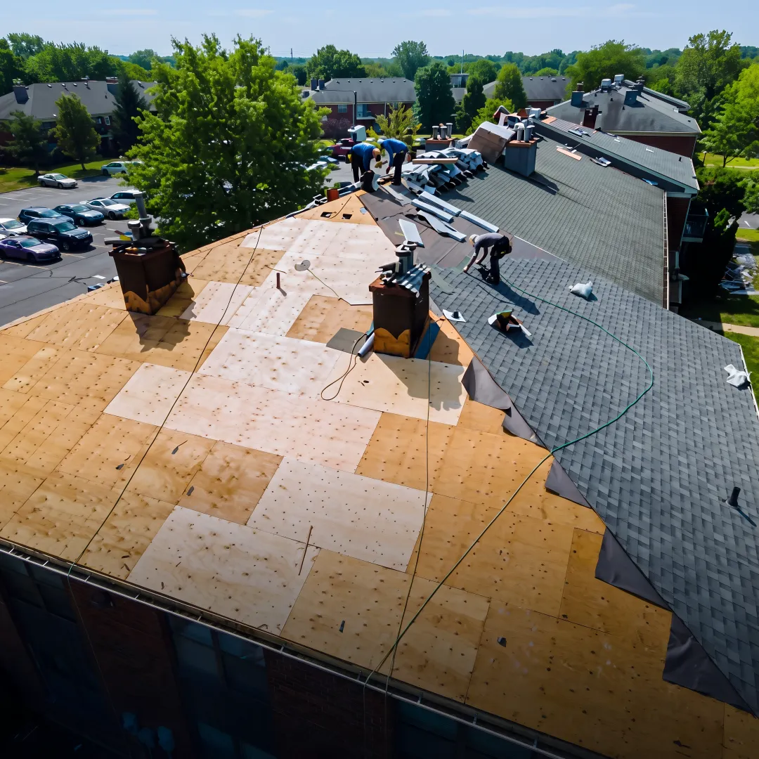 Roofing team installing protective shingles