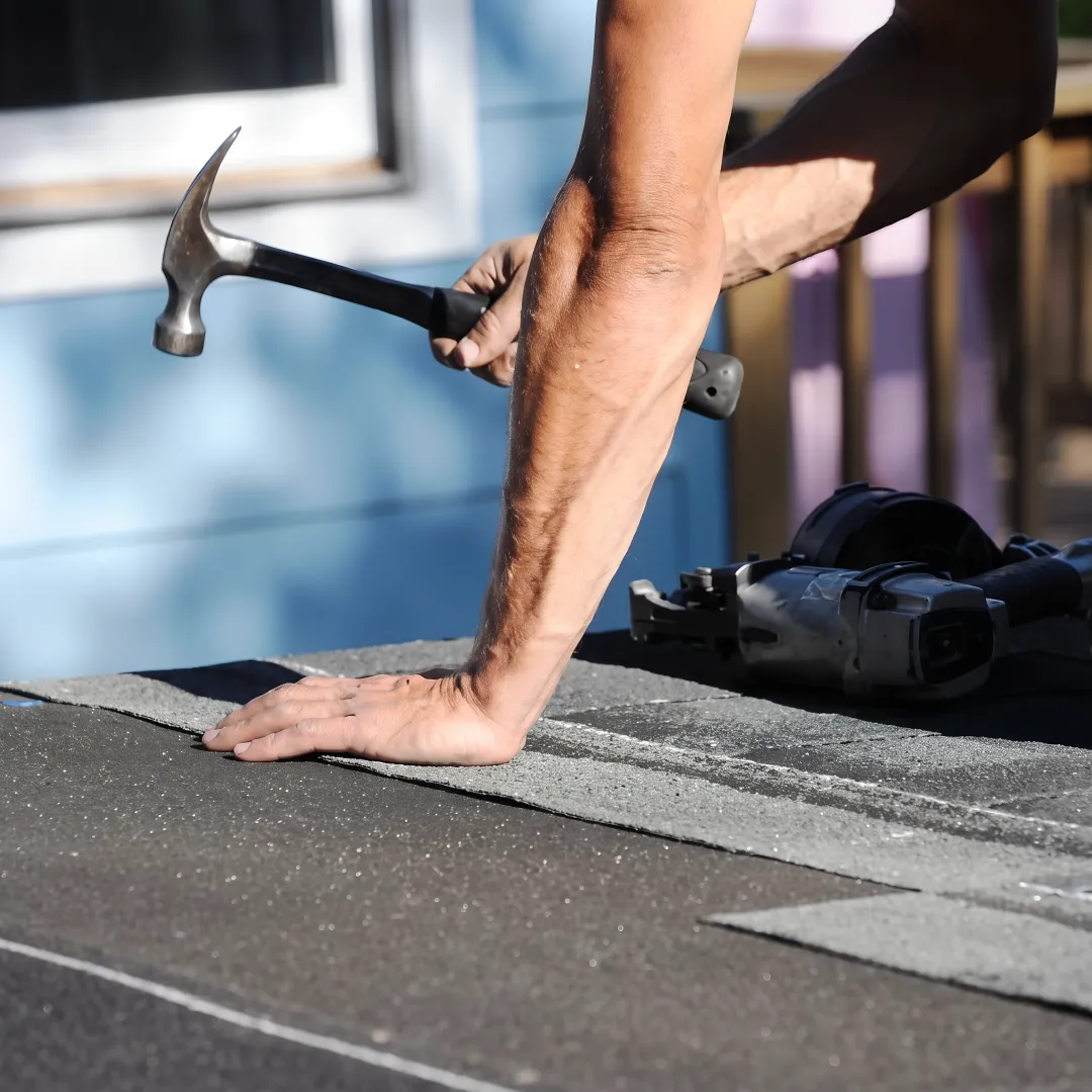 Roofing professional inspecting a residential roof