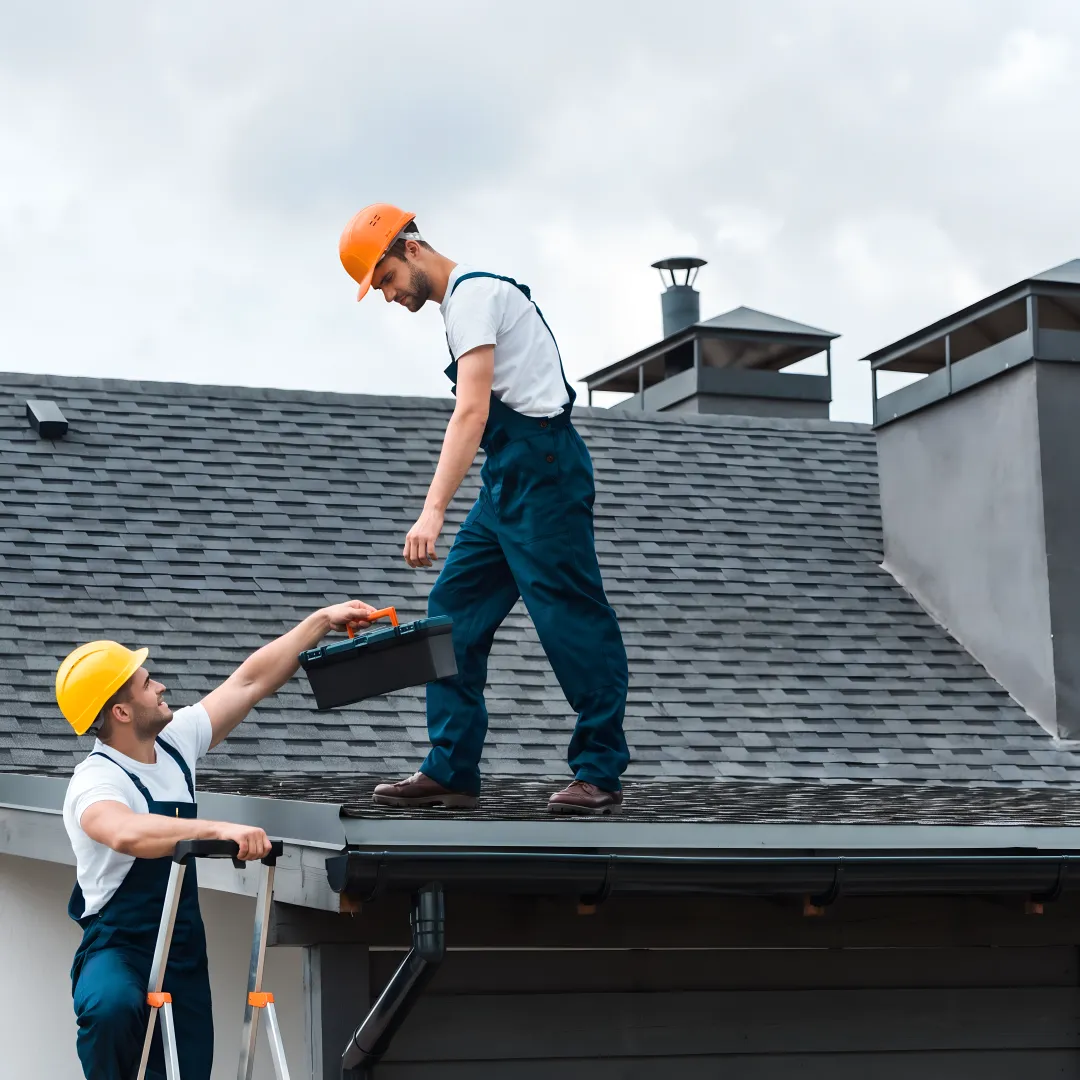 Roofers installing fortified shingles