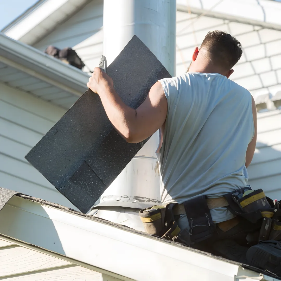Roofing technician repairing flashing on a home