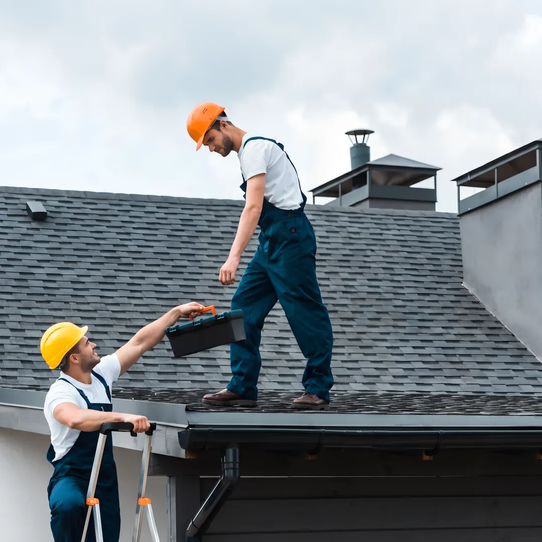 Roofer inspecting a completed shingle roof