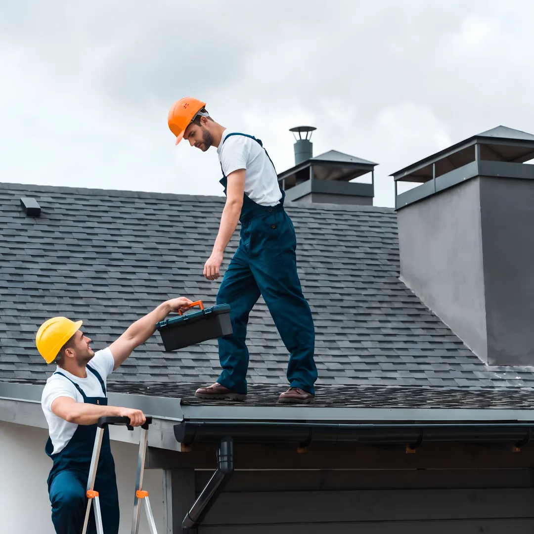 Roofer repairing shingles and flashing