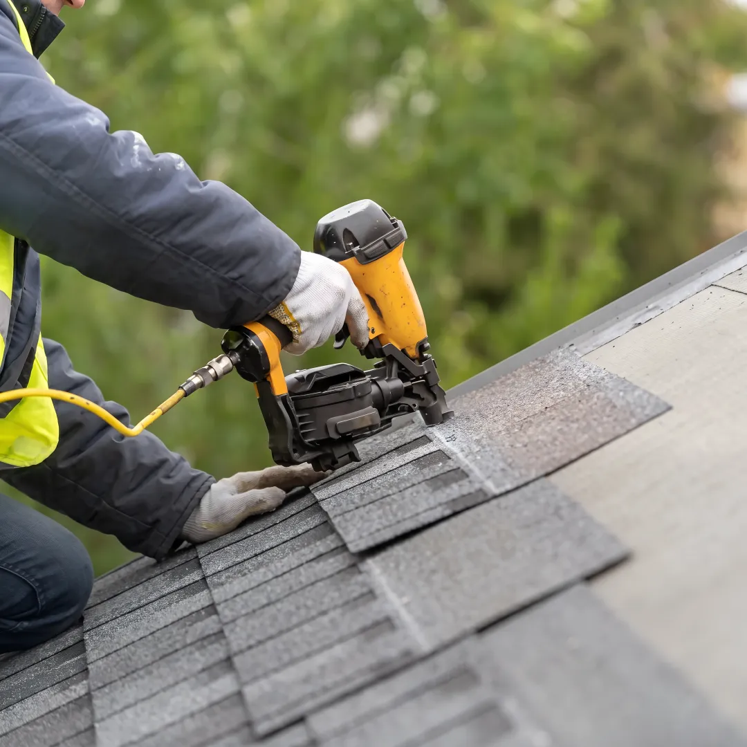 Roofing professional inspecting commercial shingle roof