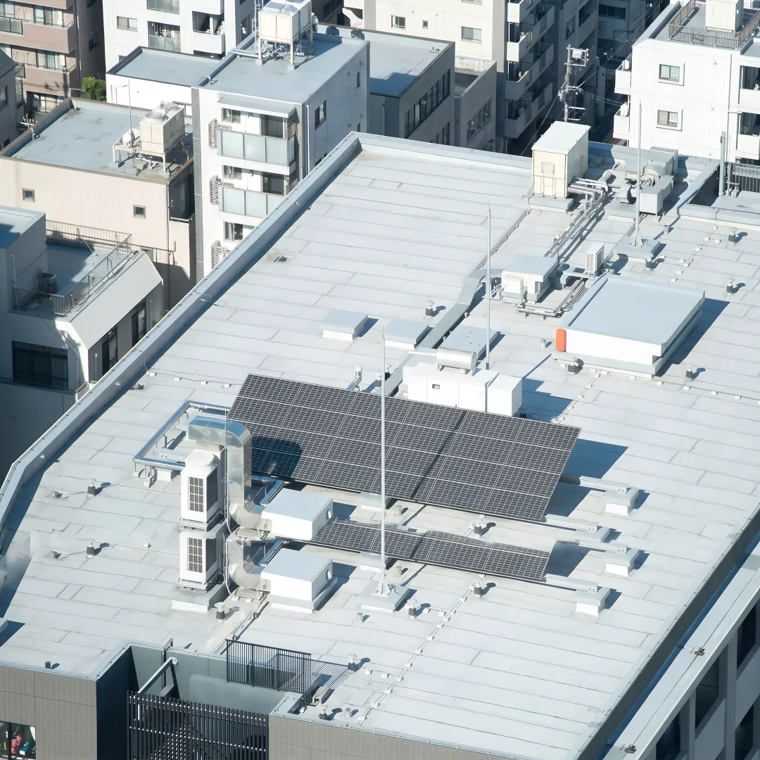 Roofer inspecting a commercial roof