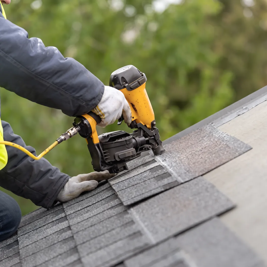 Installer restoring a residential shingle roof