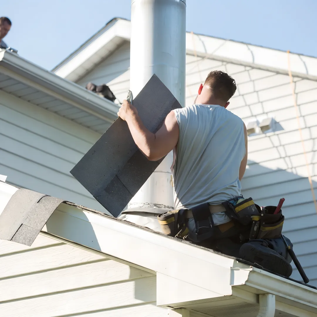 Roofing technician repairing damaged flashing