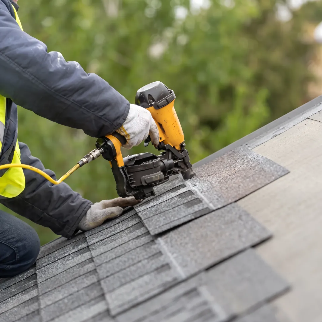 Roofer inspecting a residential roof