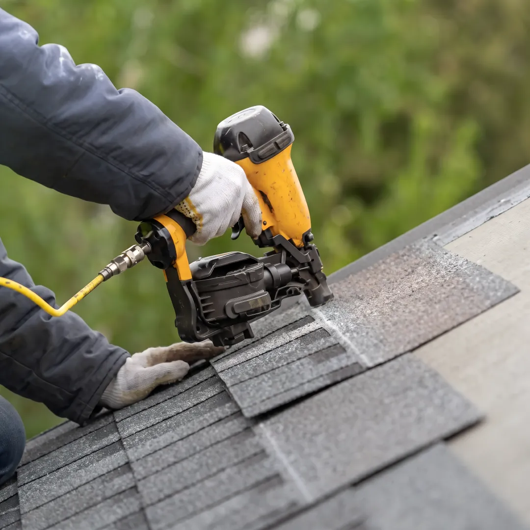 Roofer inspecting a completed residential roof
