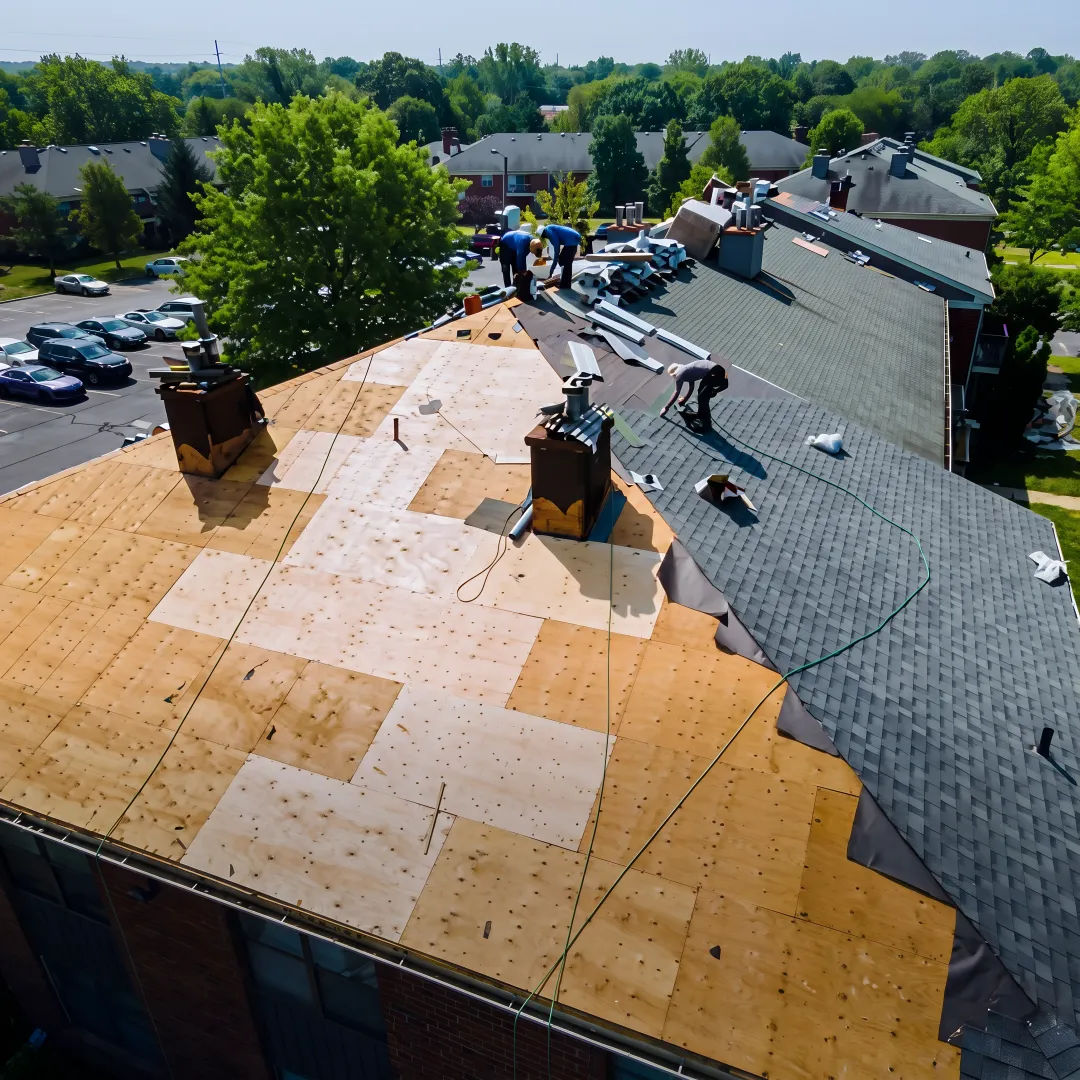 Roofing crew installing new shingles