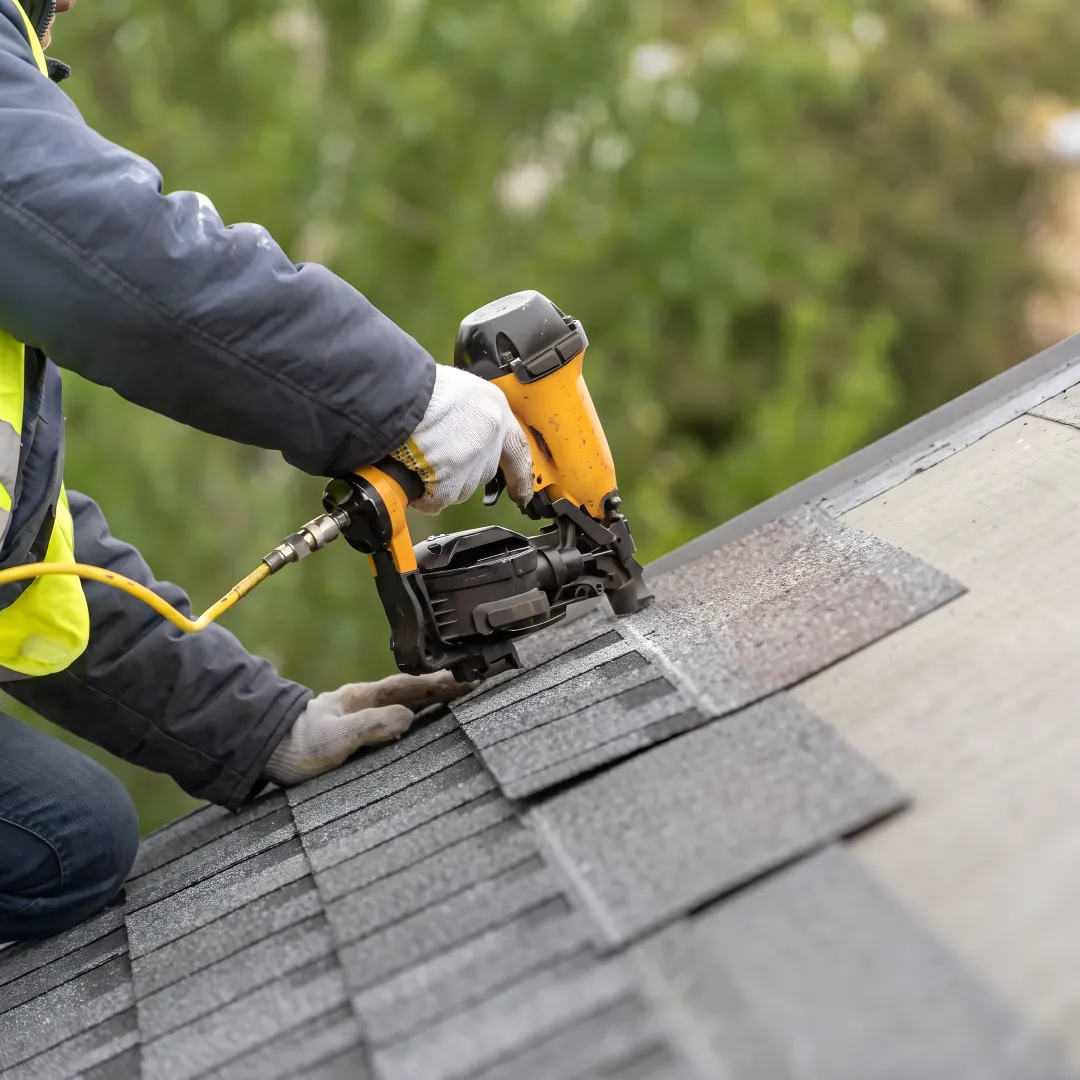 Inspector checking an asphalt shingle roof