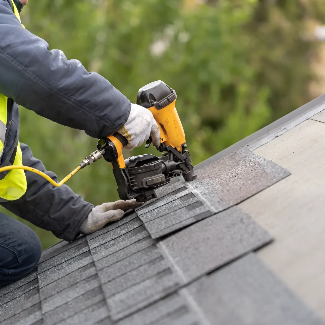 Roofing team installing a reflective shingle roof