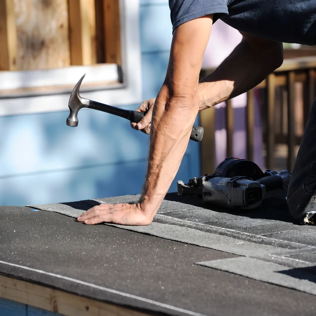 Roofing professional inspecting a residential roof