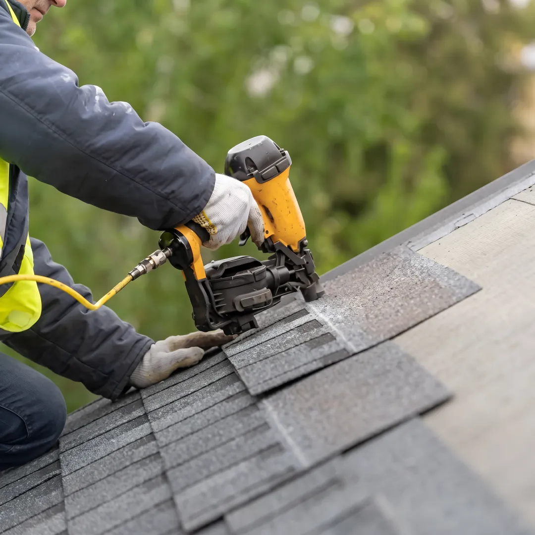 Roofer installing high-performance shingles