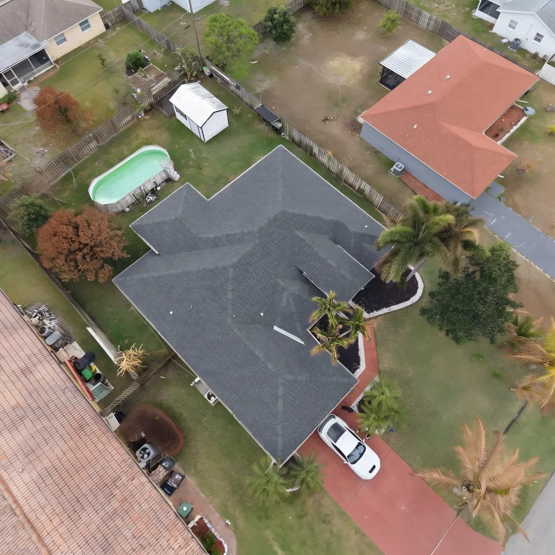 Roofer inspecting a painted metal roof