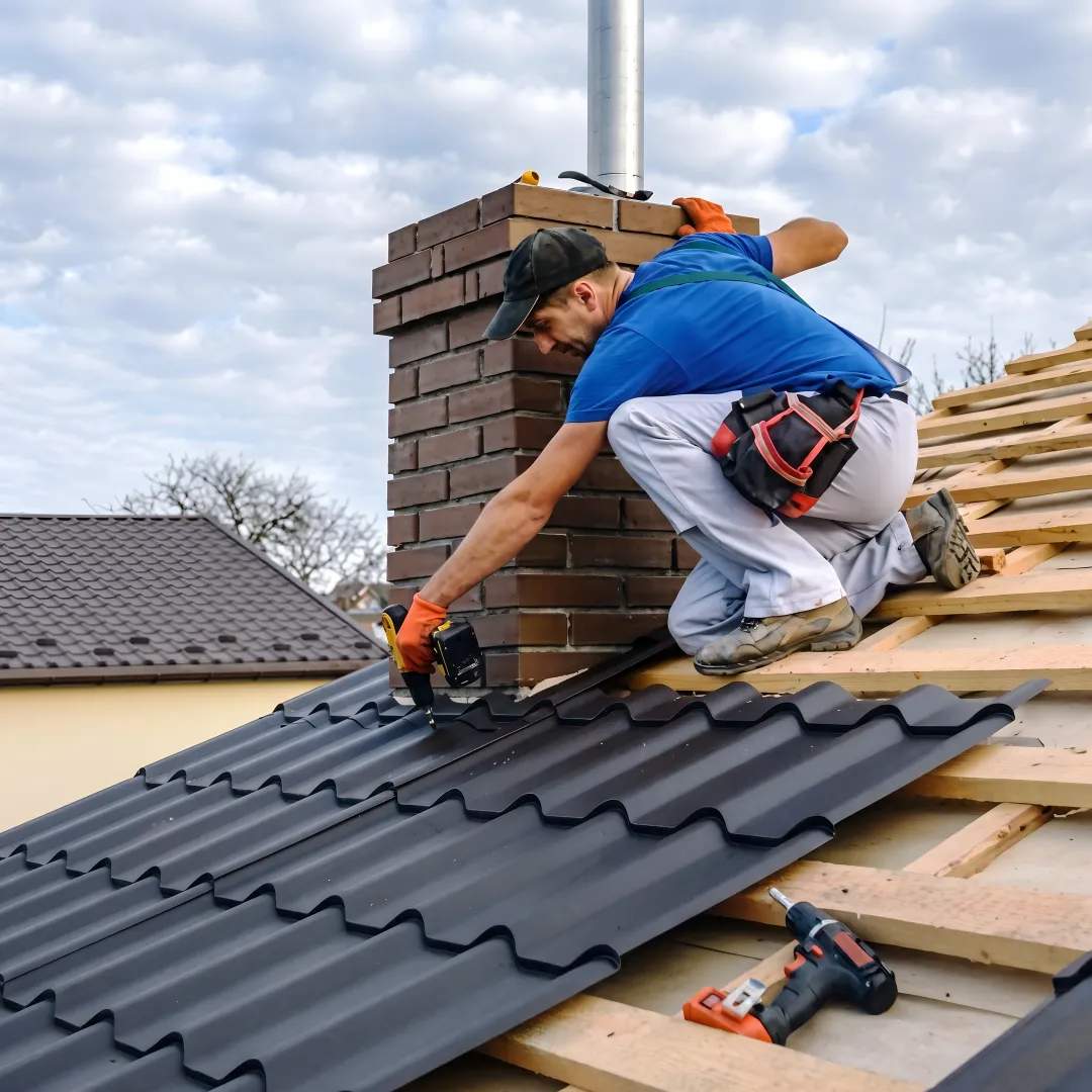 Roofers installing standing seam metal panels