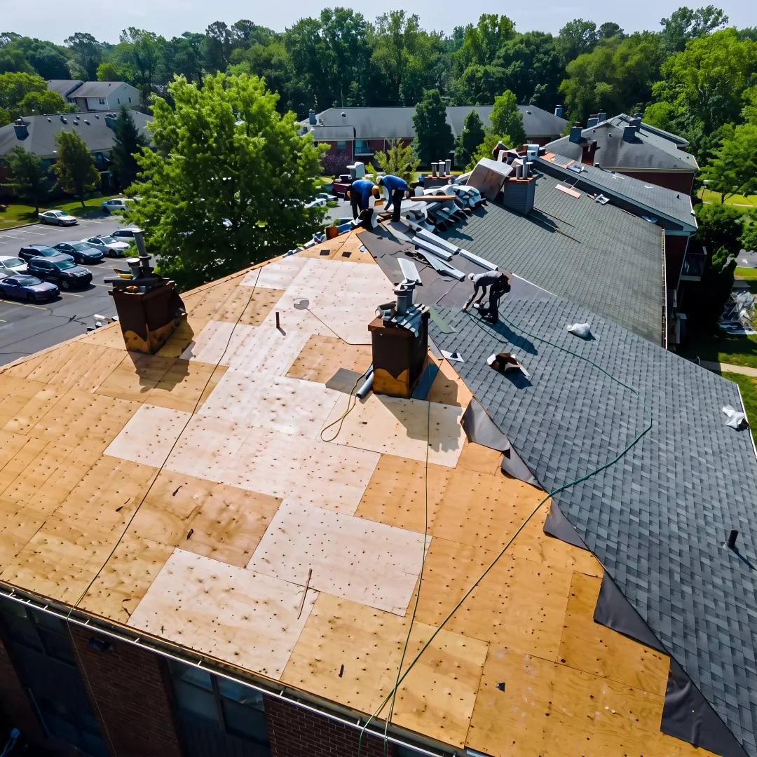Roofing crew installing protective shingles