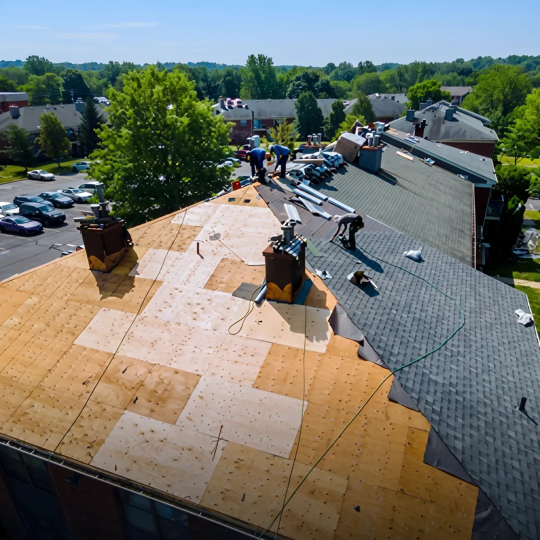 Roofers installing shingles on a home