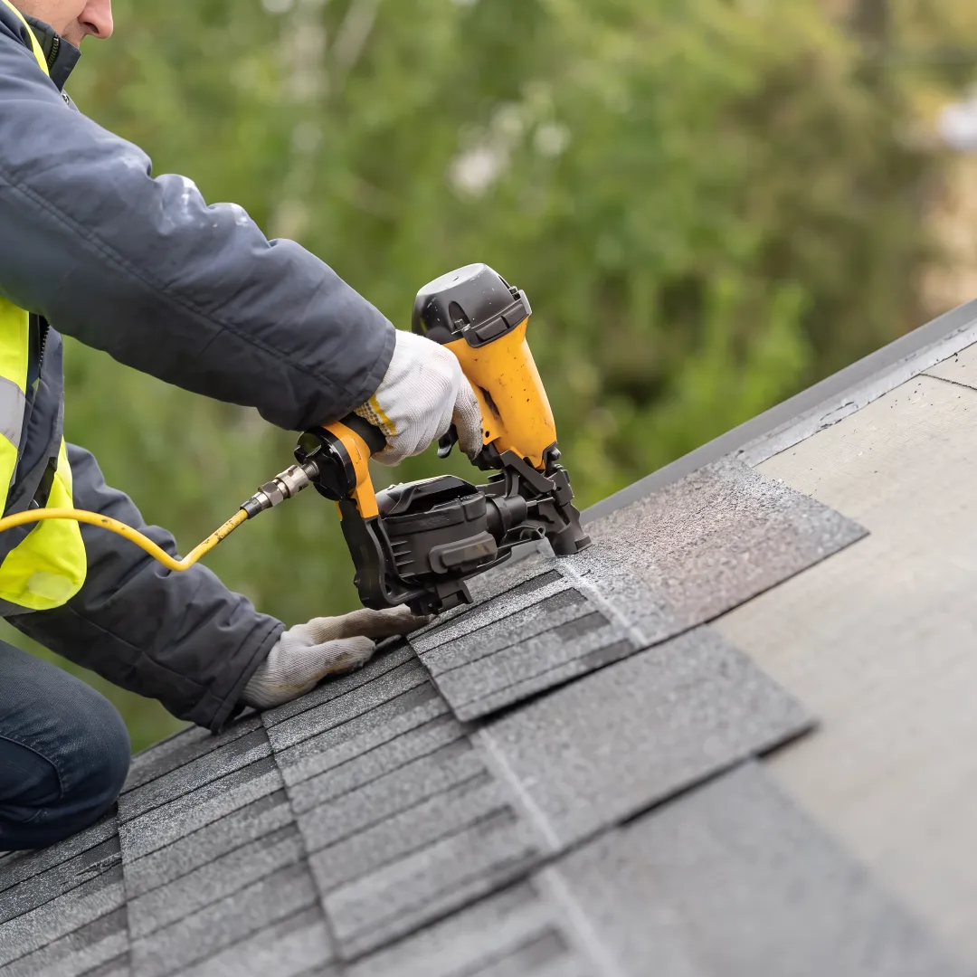 Installer securing shingles on a Florida roof