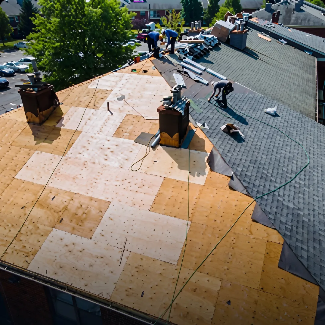 Roofer installing metal roofing panels