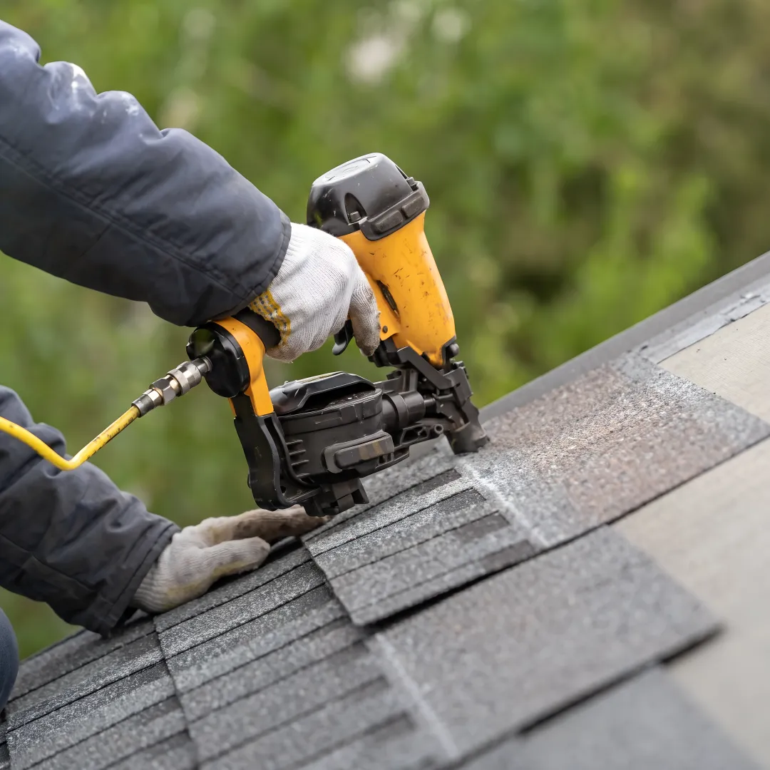 Roofer inspecting a Florida residential roof