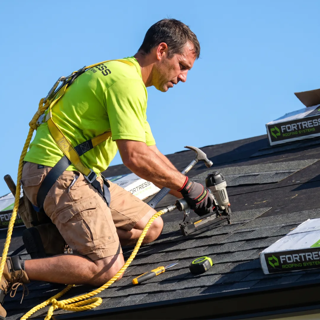 Installer placing shingles on a Florida roof