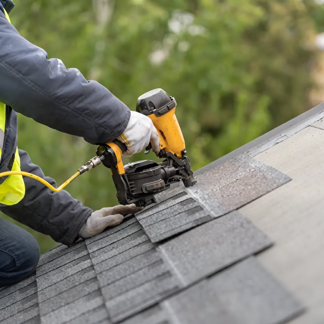 Installer inspecting roof materials on a Miami home