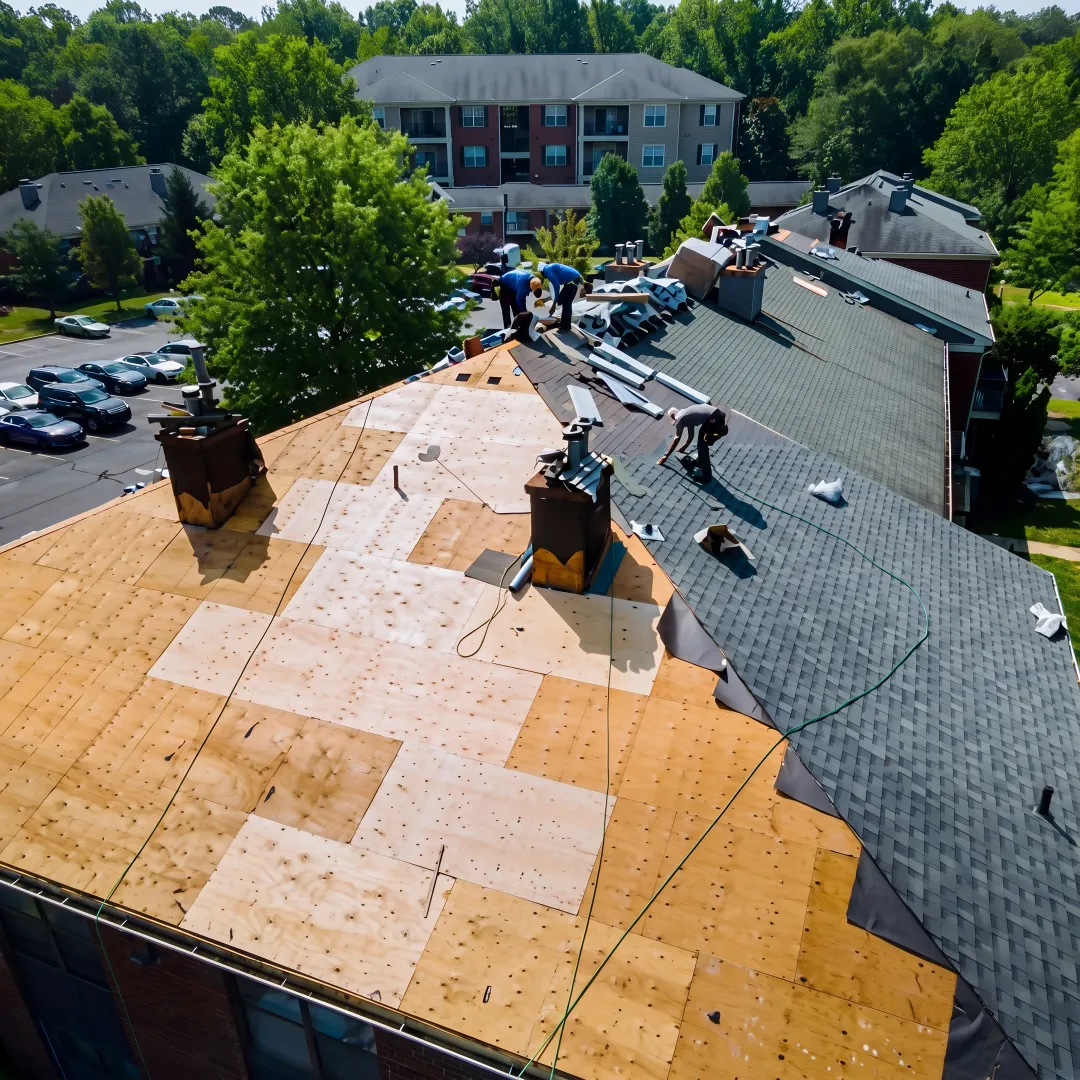 Installer fitting roof shingles on a home