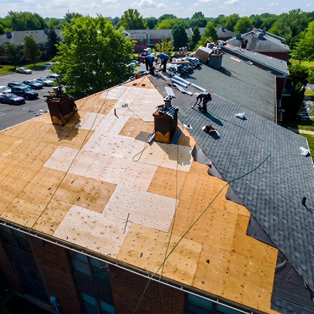 Roofer installing standing-seam metal panels