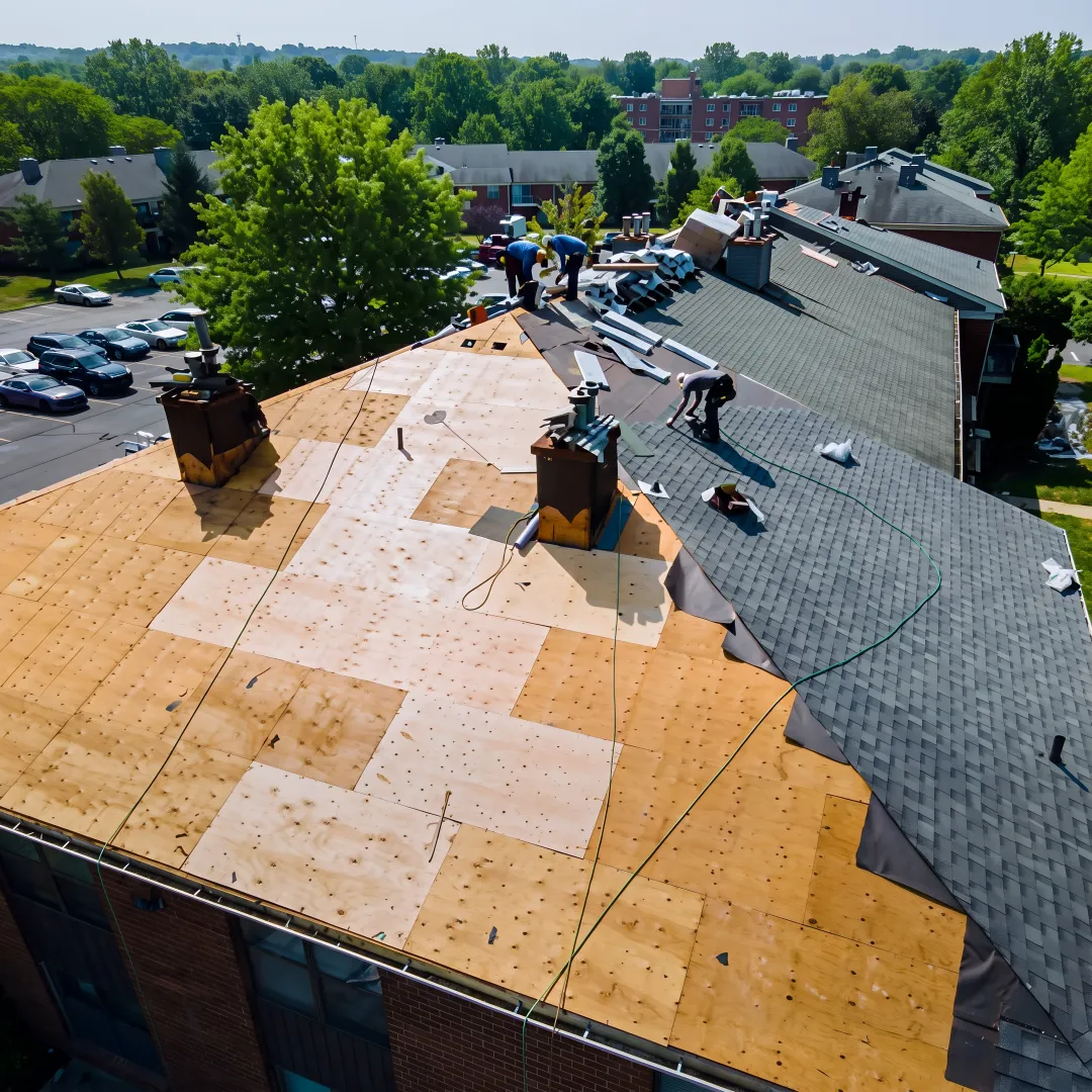 Installer fitting shingles on a South Florida roof