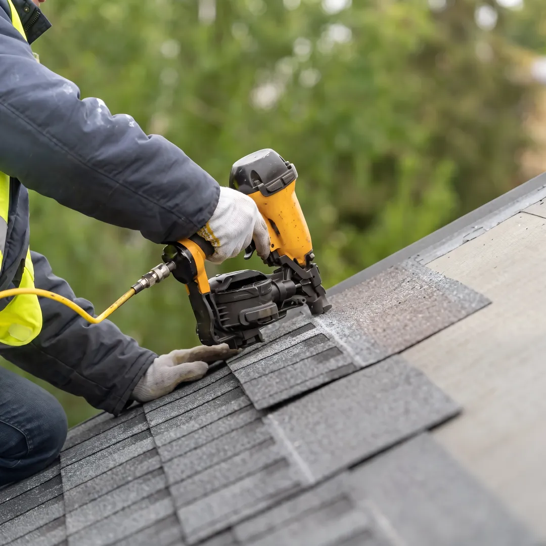Crew installing a reflective shingle roof