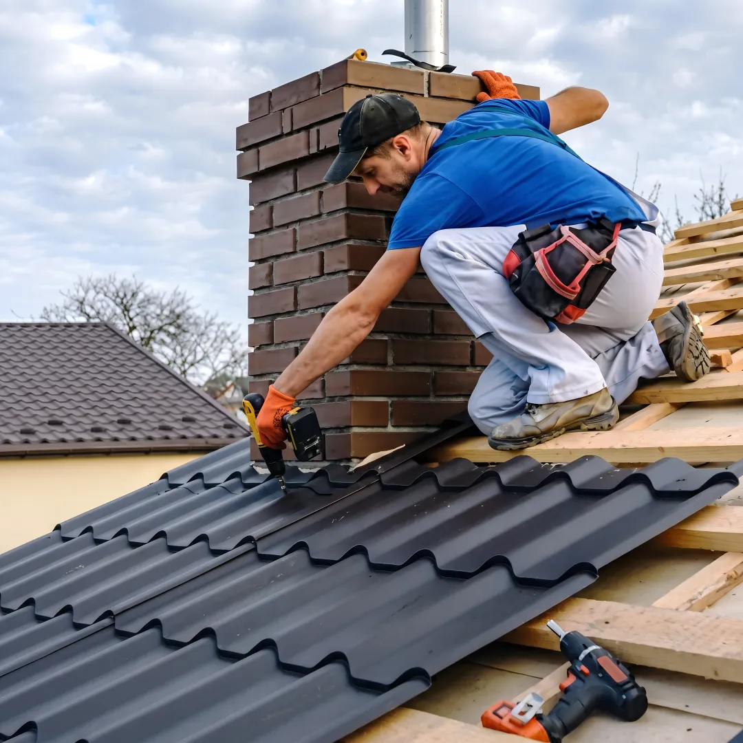 Installer fitting textured metal roof panels