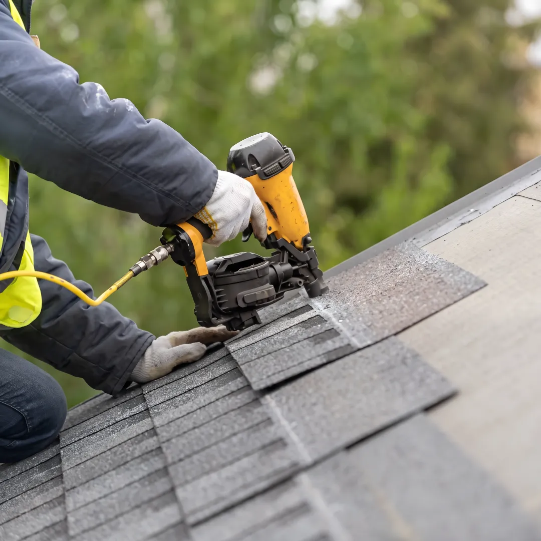 Roofing installer inspecting a newly completed roof