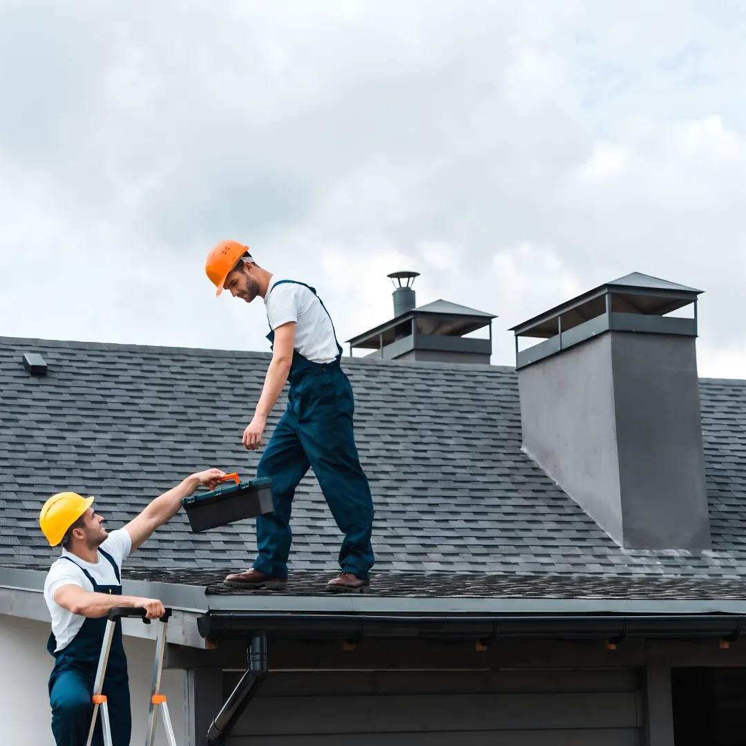 Roofer installing storm-resistant shingles