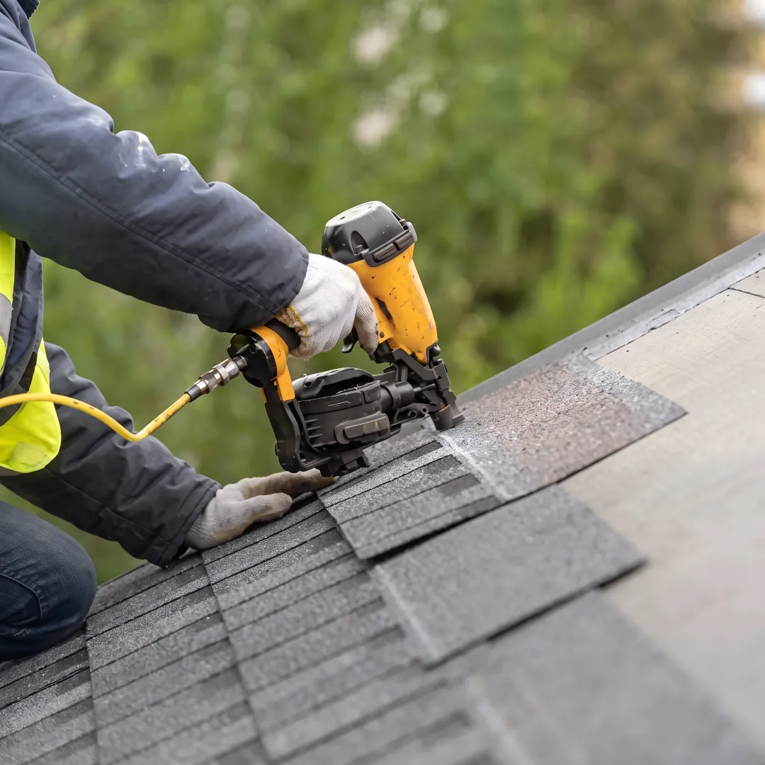 Roofing professional inspecting a repaired roof section