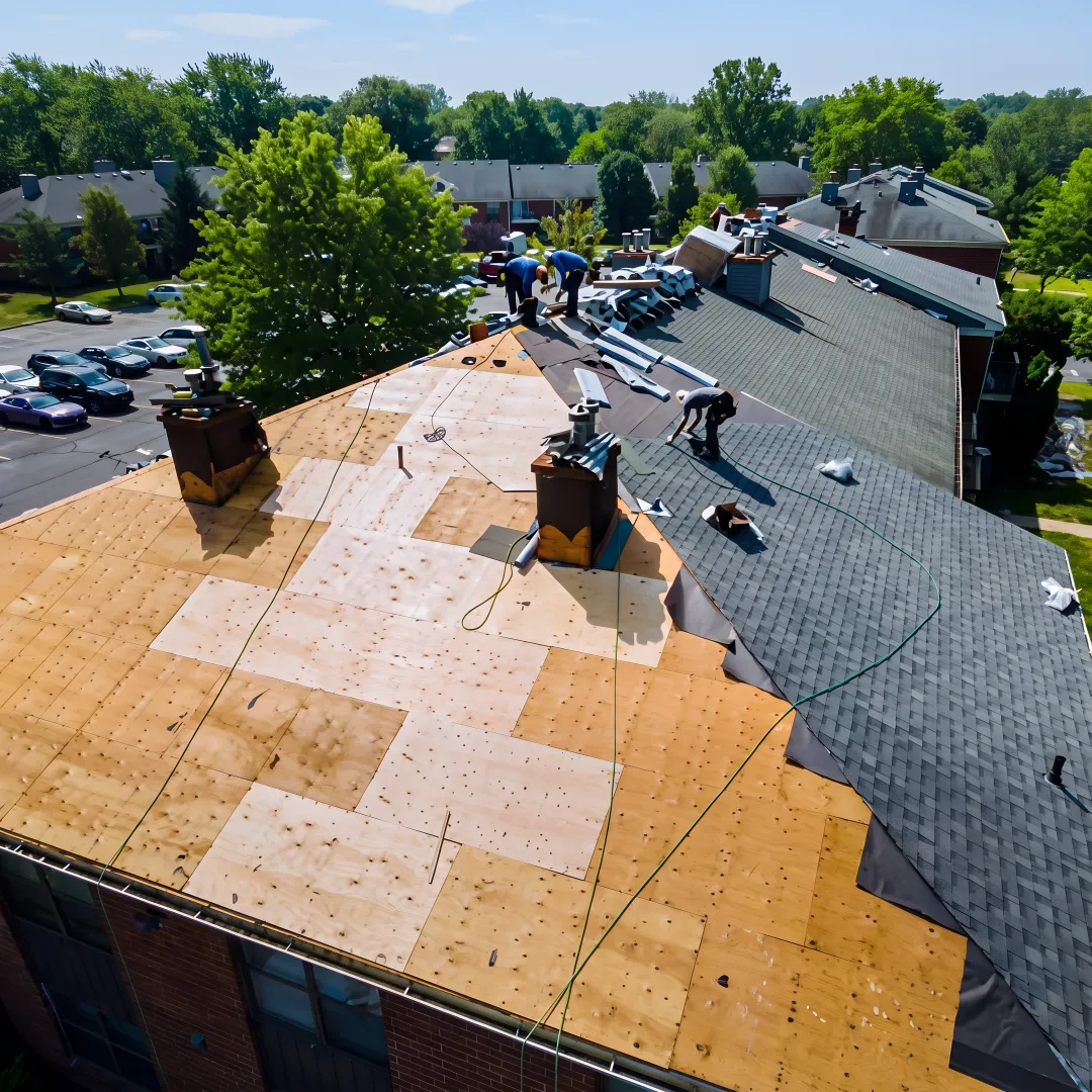Roofer repairing shingles on a home