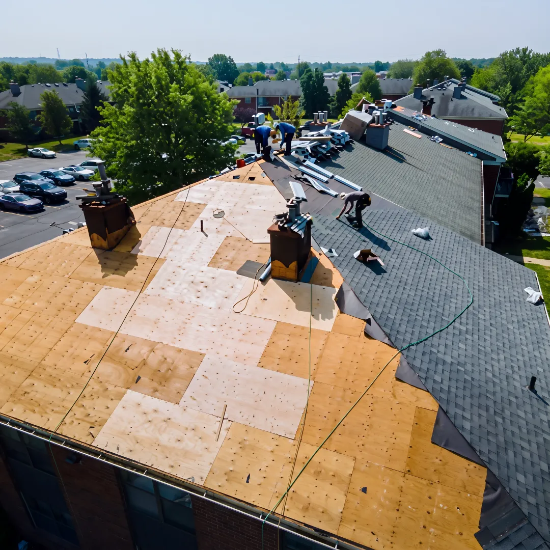 Roofing professional repairing a covered patio roof