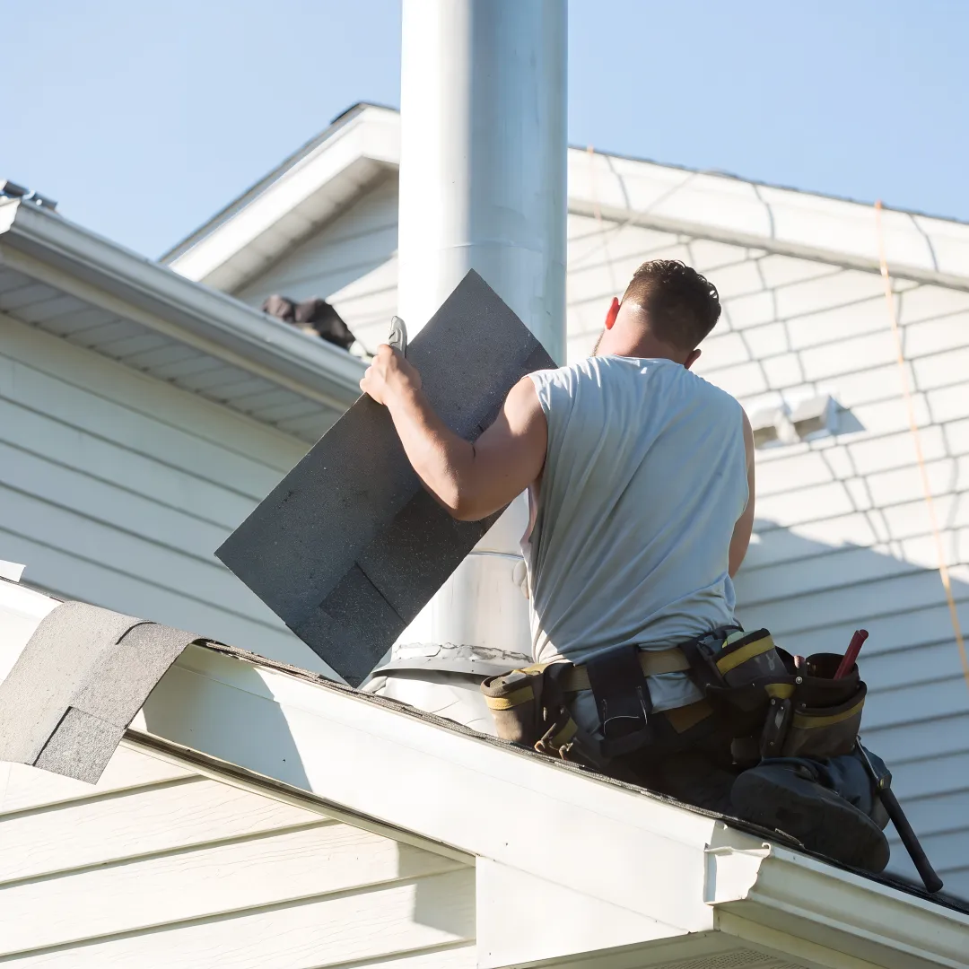 Roofing technician repairing flashing around a roof vent
