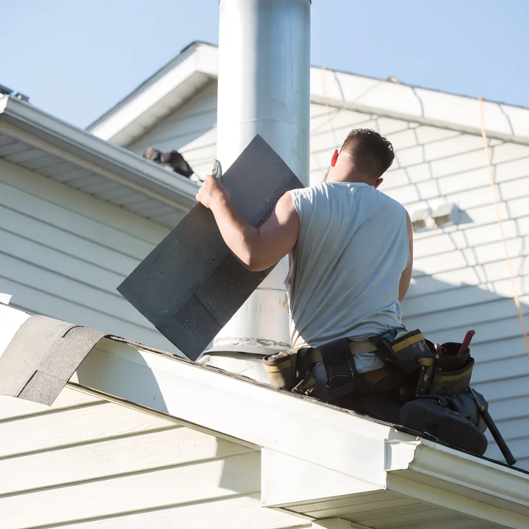 Roofing professional repairing shingles on a Florida roof