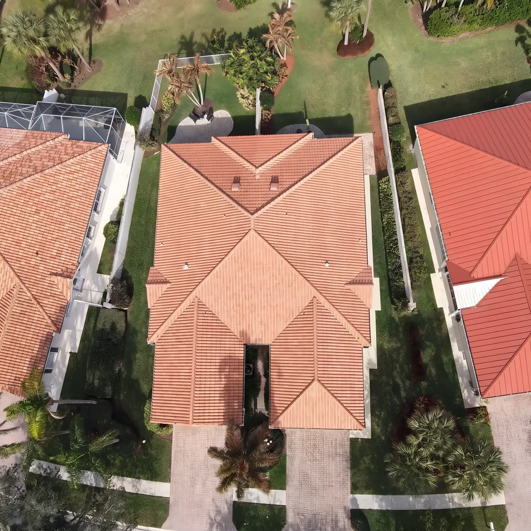 Roofing specialist inspecting clay roof tiles