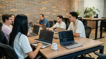 Latin American software development team collaborating in modern tech office workspace