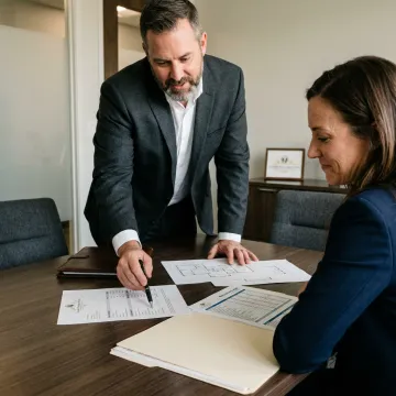 Advisor reviewing fix and flip financing documents with investor